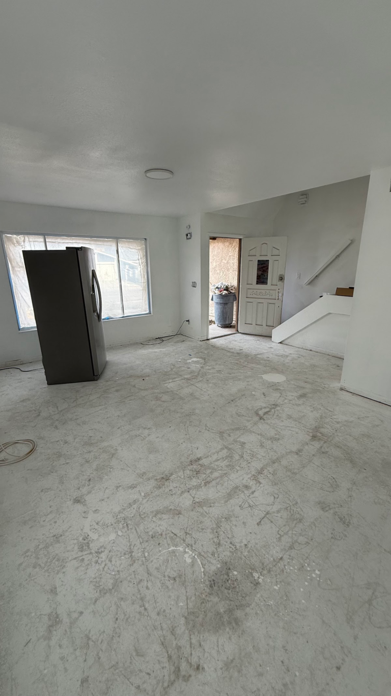 Living room prepared for new flooring during the Las Vegas home restoration project.