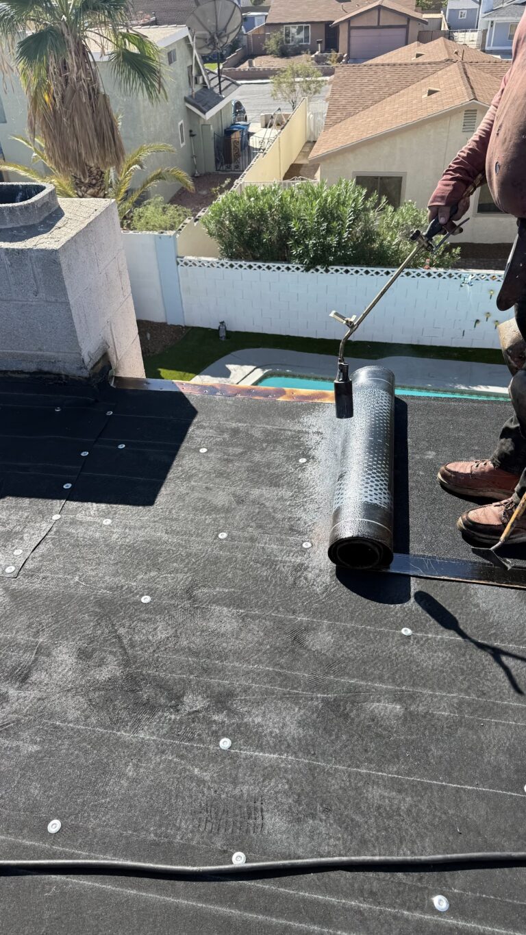 Membrane installation along roof perimeter during the Las Vegas home restoration project.