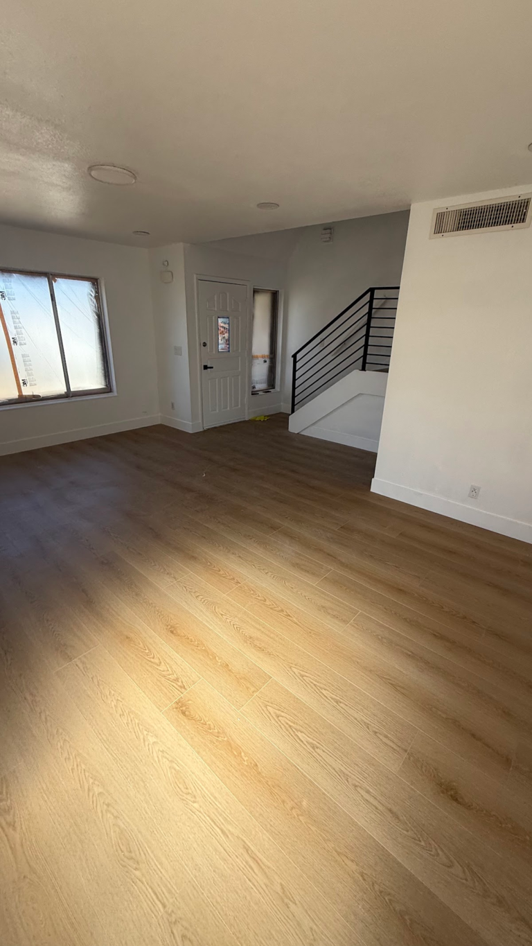 Open living area with finished floor during the Las Vegas home restoration project.