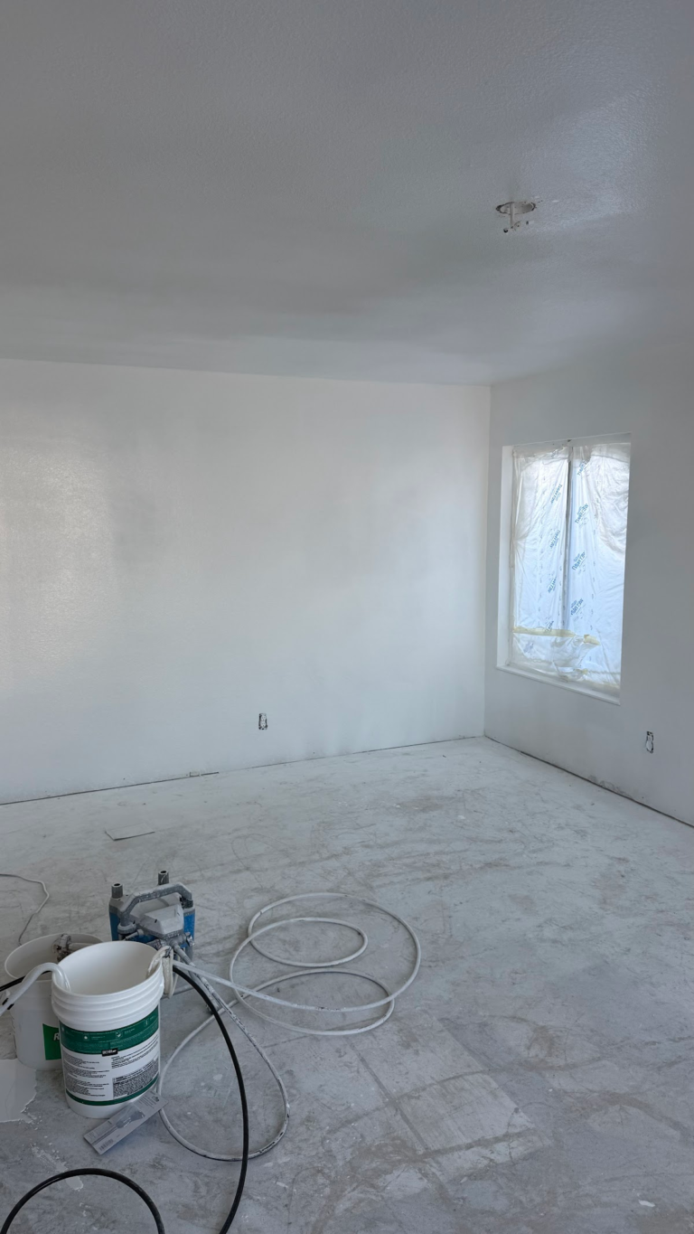 Painting equipment in bedroom during the Las Vegas home restoration project.