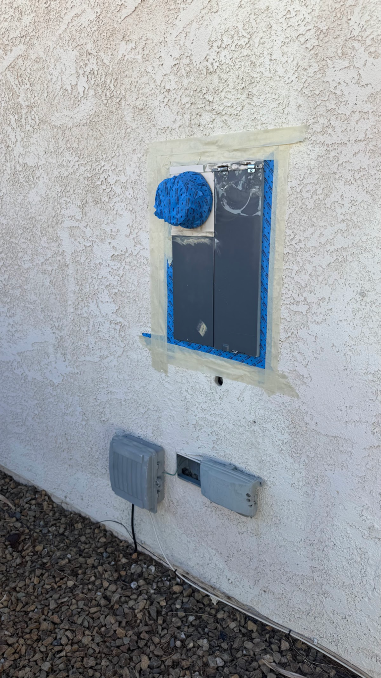 Protected electrical panel during exterior work during the Las Vegas home restoration project.