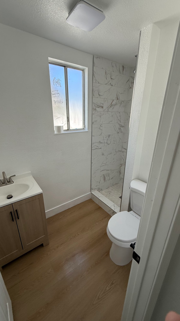 Remodeled bathroom with shower window and vanity during the Las Vegas home restoration project.