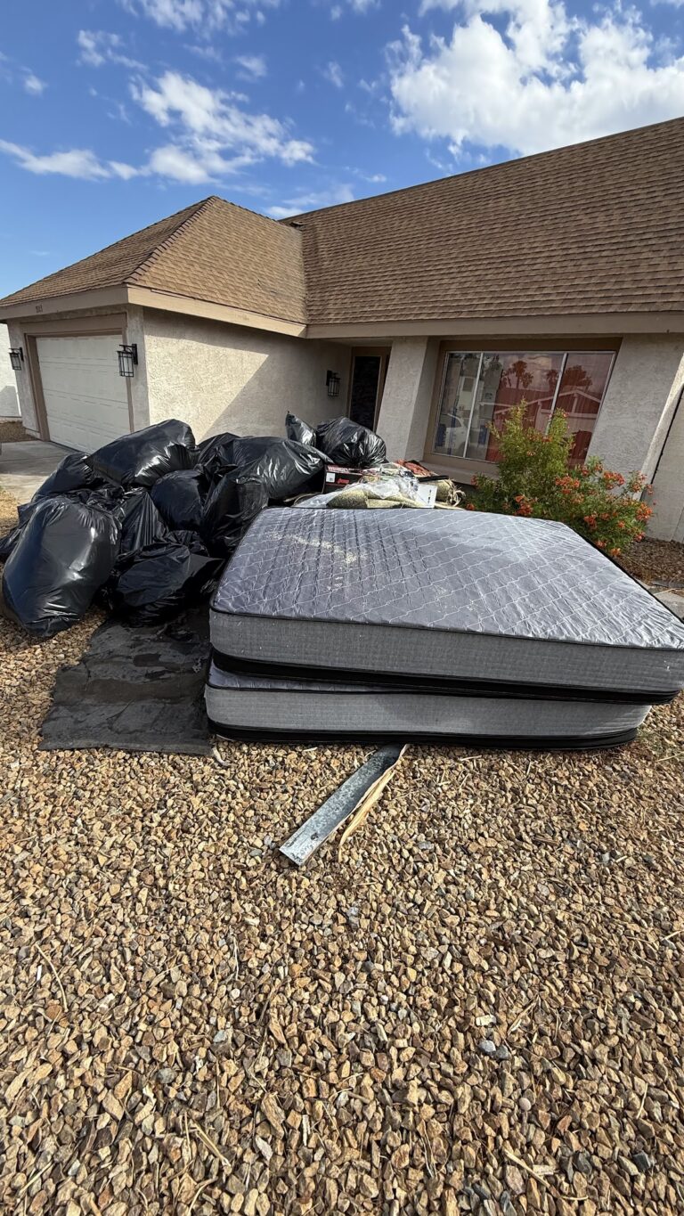 Removed roofing materials stacked in front yard during the Las Vegas home restoration project.