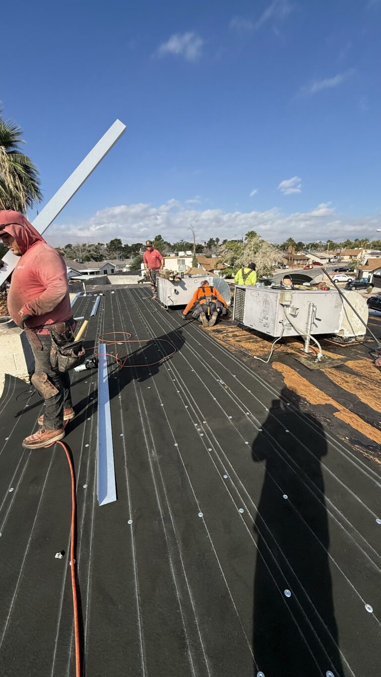 Roof membrane installation along roof perimeter during the Las Vegas home restoration project.