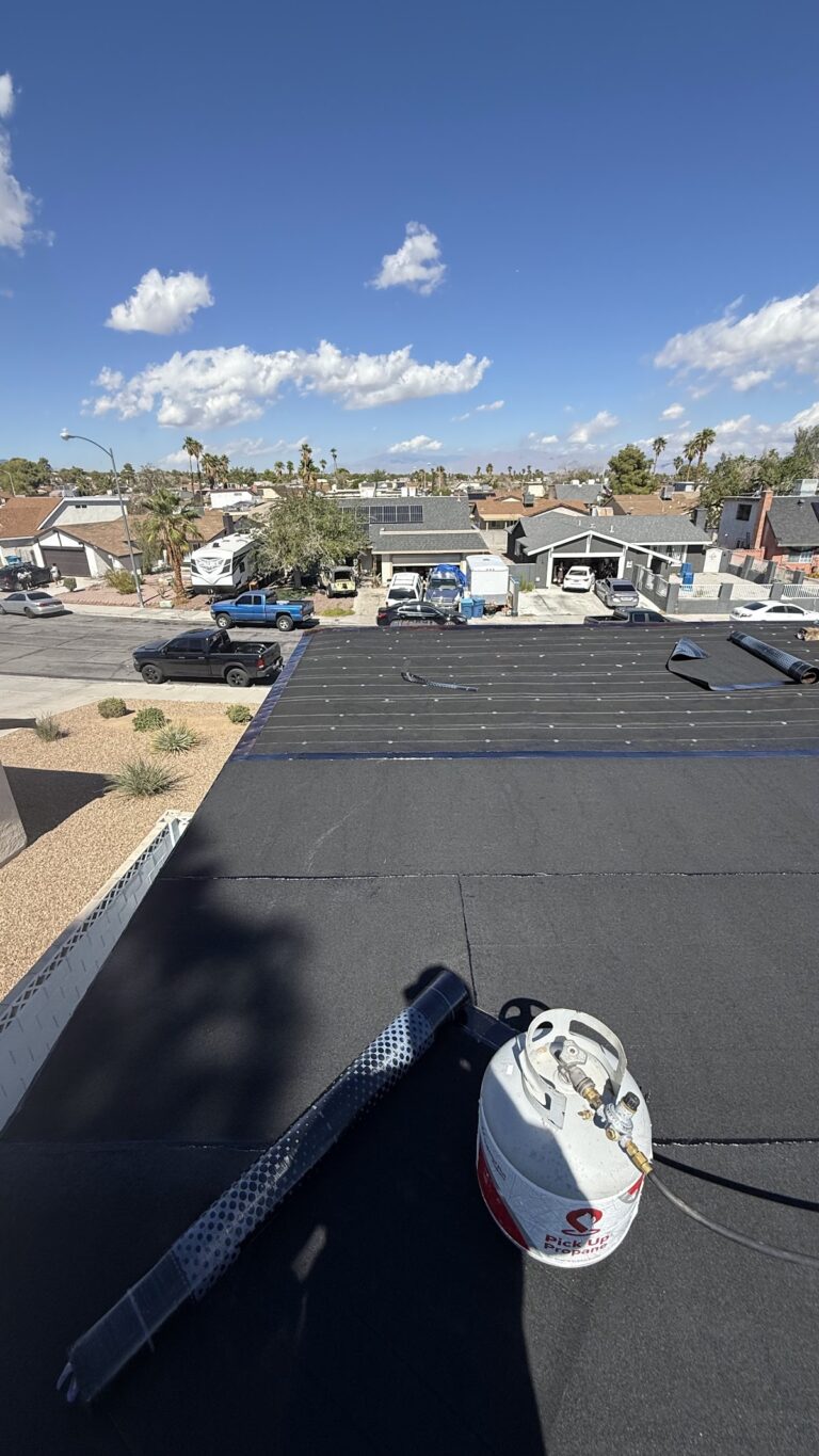 Roof membrane laid beside raised roof edge during the Las Vegas home restoration project.