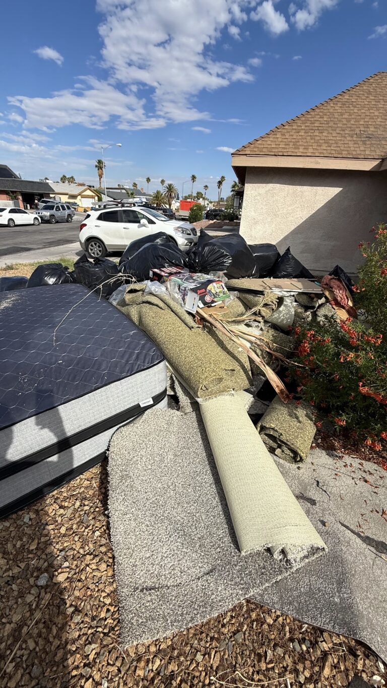 Roof tear-off debris and insulation boards during the Las Vegas home restoration project.