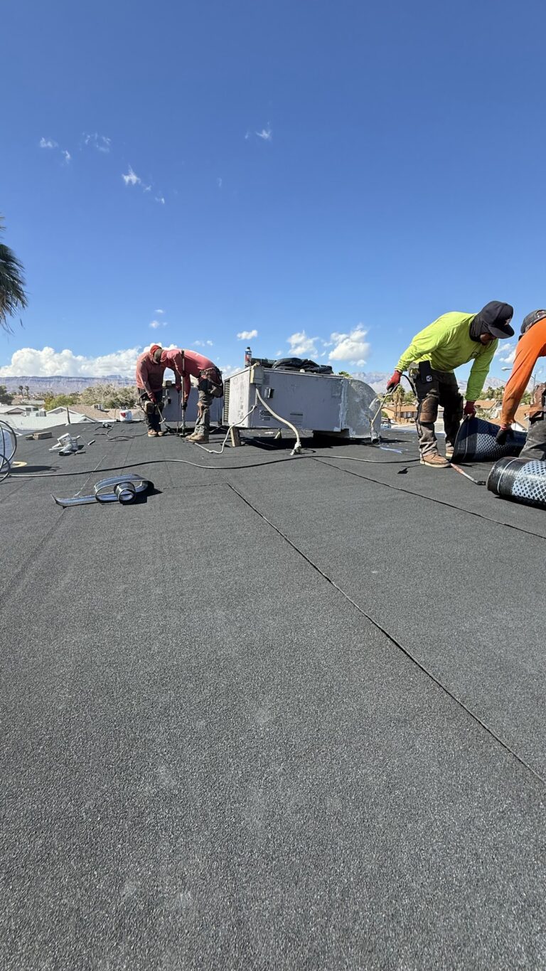 Roofing crew fitting membrane seams during the Las Vegas home restoration project.