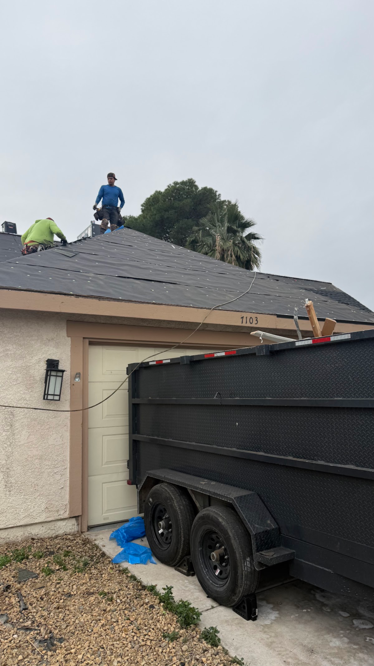 Roofing crew working over garage during the Las Vegas home restoration project.