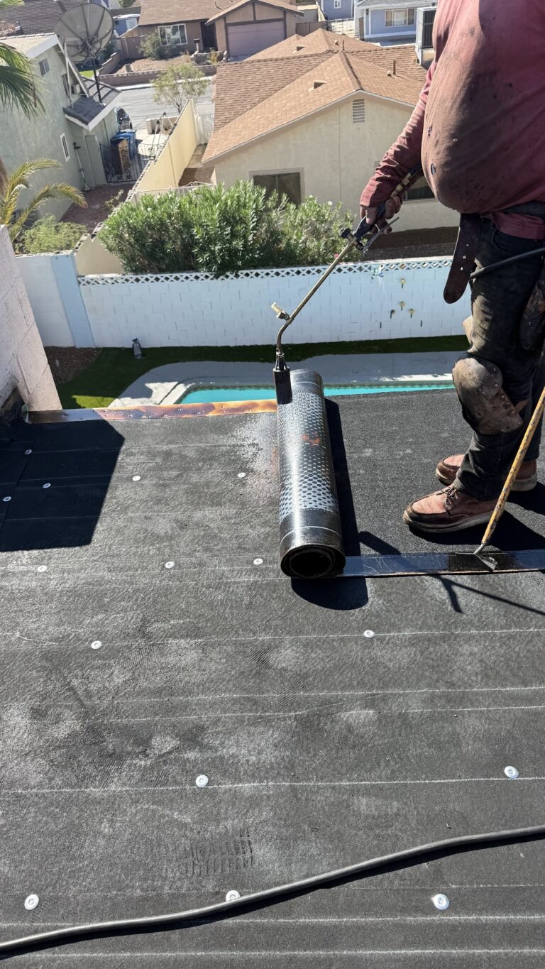 Roofing membrane roll beside perimeter wall during the Las Vegas home restoration project.