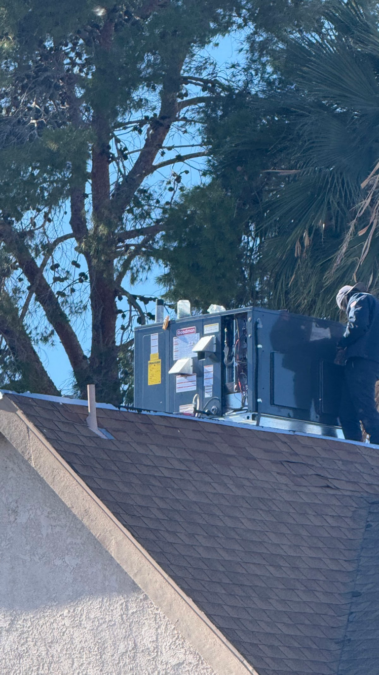Rooftop HVAC equipment beside shingle roof during the Las Vegas home restoration project.