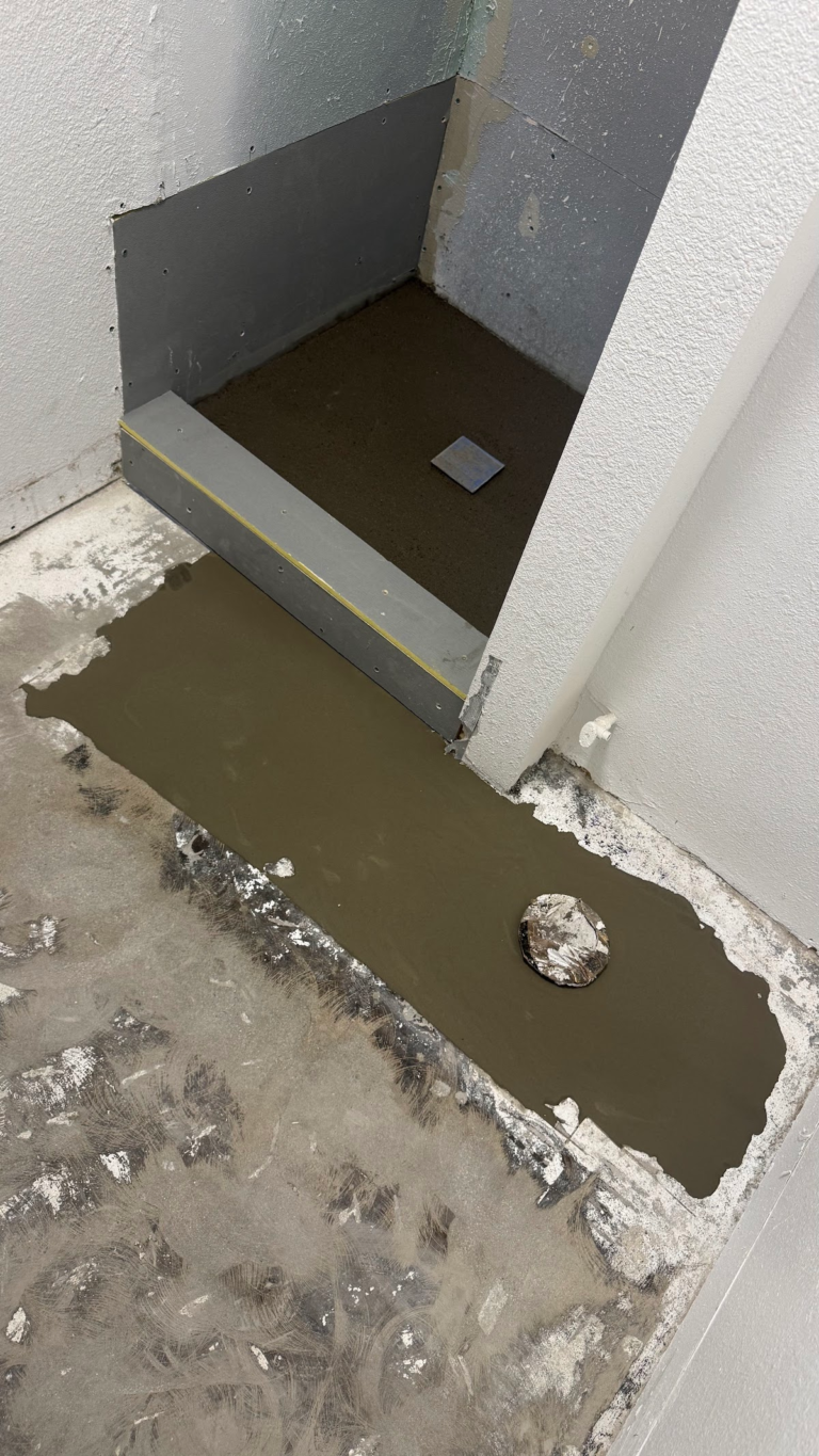 Shower base and floor repair in progress during the Las Vegas home restoration project.