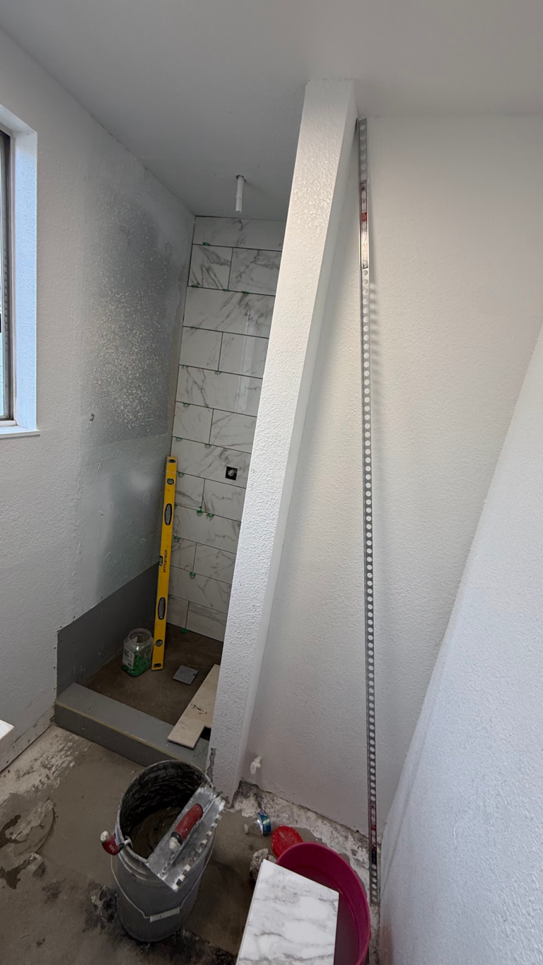 Shower remodel with wall tile and tools during the Las Vegas home restoration project.