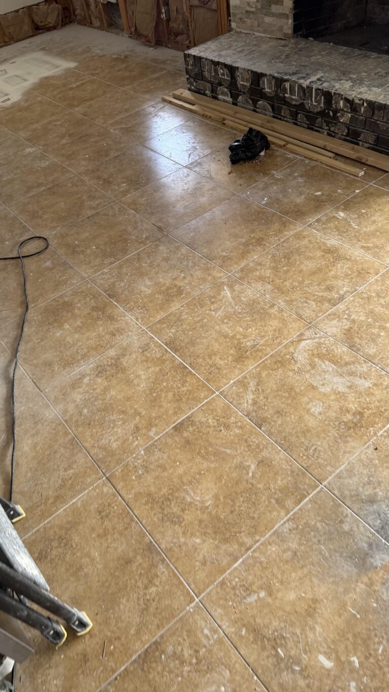 Water on tile flooring beside fireplace during the Las Vegas home restoration project.