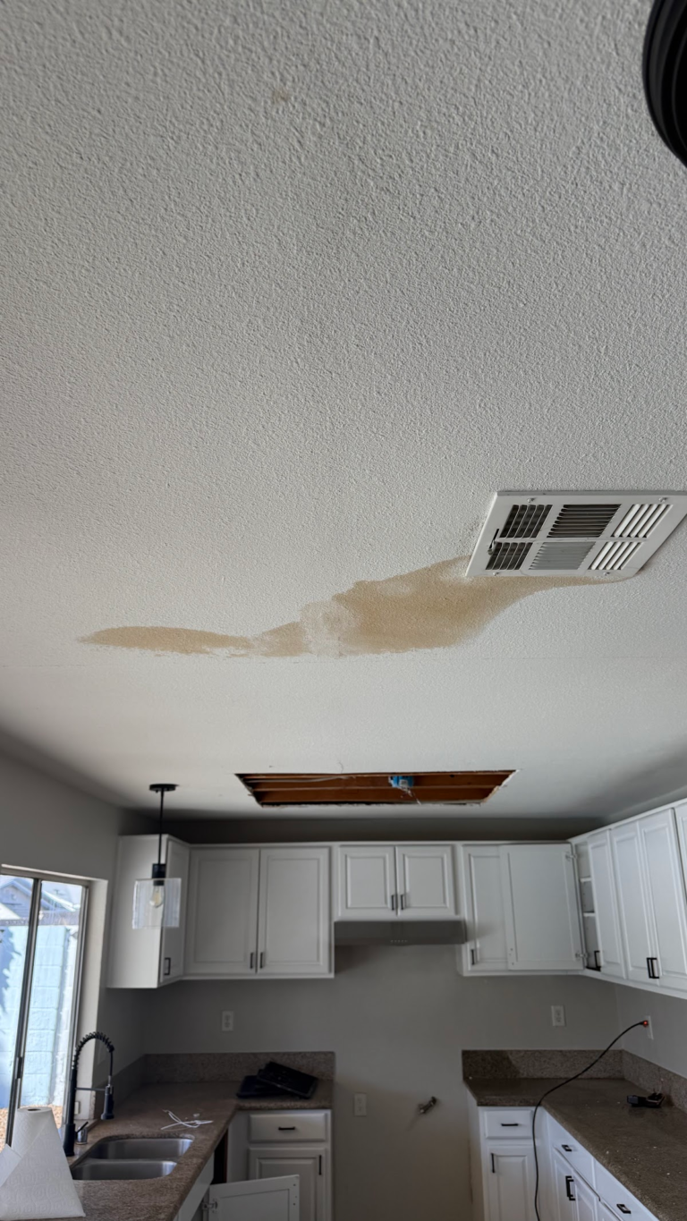 Water stain beside ceiling vent and access opening during the Las Vegas home restoration project.